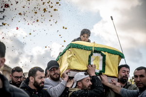 A young relative is carried on a coffin at a funeral for three children - Narges (8), Mohammed (11) and Zainab (15) - and their mother, Khadija, in Jibchit, Nabatieh district. The family died following the Israeli airstrike while displaced. Civilians killed in heavy bombardment were buried in a mass funeral in the village of Jibchit, southern Lebanon. Families returned during a temporary ceasefire to lay victims, many killed in earlier strikes, to rest after being unable to access the cemetery. Mourners carried coffins through the damaged village, reflecting the heavy civilian toll of the conflict.