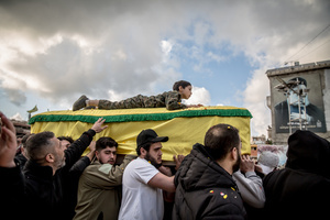 A young relative is carried on a coffin at a funeral for three children - Narges (8), Mohammed (11), and Zainab (15) - and their mother, Khadija, in Jibchit, Nabatieh district. The family died following the Israeli airstrike while displaced. Civilians killed in heavy bombardment were buried in a mass funeral in the village of Jibchit, southern Lebanon. Families returned during a temporary ceasefire to lay victims, many killed in earlier strikes, to rest after being unable to access the cemetery. Mourners carried coffins through the damaged village, reflecting the heavy civilian toll of the conflict.
