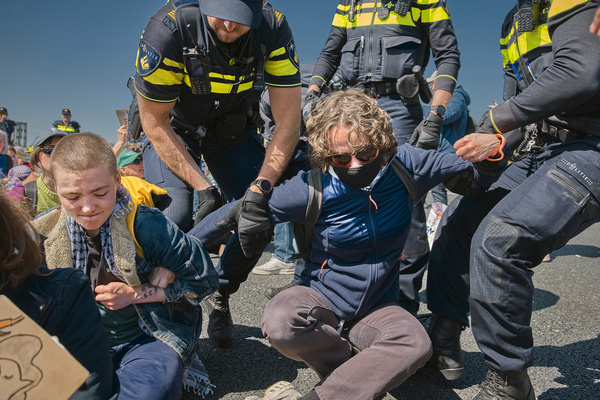 Protesters holding each other tightly in an attempt to prevent arrest during the A12 blockade. Climate activists from Extinction Rebellion, Debt for Climate, and Utrecht for Palestine blocked the A12 ring road near De Meern (at knooppunt Oudenrijn) in Utrecht. They protested to demand an immediate end to Dutch fossil fuel subsidies, which they say amount to thirty-nine point seven billion euros to forty-six point four billion euros (€39.7–€46.4 billion) annually and exacerbate the climate crisis.