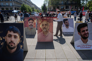 The People's Mojahedin Organization of Iran also known as Mojahedin-e-Khalq display photos of the victims of the Iranian demonstrations in Paris during the May Day protest. Tens of thousands of trade unionists and grassroots activists gathered in Paris to celebrate the achievements of the labor movement and raise awareness of workers’ rights.