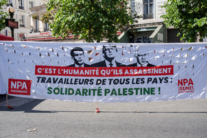 A banner shows the photo of French President Emmanuel Macron, the American President Donald Trump and the Israeli President Benjamin Netanyahu. It says " They are murdering and workers from all countries says: Solidarity with Palestine!" Tens of thousands of trade unionists and grassroots activists gathered in Paris to celebrate the achievements of the labor movement and raise awareness of workers’ rights.
