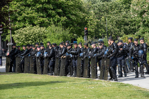 The riot police stand with shields at the Place de la Nation square in Paris. Tens of thousands of trade unionists and grassroots activists gathered in Paris to celebrate the achievements of the labor movement and raise awareness of workers’ rights.