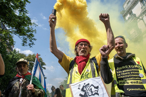 Protesters use smoke flares and hold their fists during the May Day demonstration in Paris. Tens of thousands of trade unionists and grassroots activists gathered in Paris to celebrate the achievements of the labor movement and raise awareness of workers’ rights.