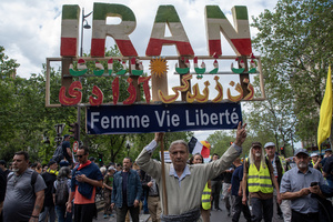 A protester holds a sign during the May Day demonstration in Paris. The sign says: "Woman, Life, Freedom!" Tens of thousands of trade unionists and grassroots activists gathered in Paris to celebrate the achievements of the labor movement and raise awareness of workers’ rights.