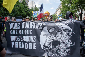 Protesters hold a banner during the May Day demonstration in Paris. Tens of thousands of trade unionists and grassroots activists gathered in Paris to celebrate the achievements of the labor movement and raise awareness of workers’ rights.