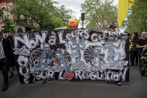 Protesters hold a banner during the May Day demonstration in Paris. Tens of thousands of trade unionists and grassroots activists gathered in Paris to celebrate the achievements of the labor movement and raise awareness of workers’ rights.