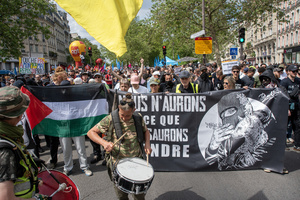 Protesters hold flags, placards and banner during the May Day demonstration in Paris. Tens of thousands of trade unionists and grassroots activists gathered in Paris to celebrate the achievements of the labor movement and raise awareness of workers’ rights.