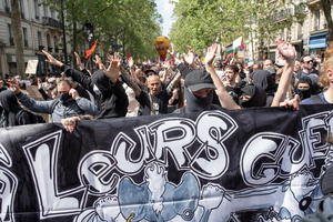 Protesters hold banner and chant slogans during the May Day demonstration in Paris. Tens of thousands of trade unionists and grassroots activists gathered in Paris to celebrate the achievements of the labor movement and raise awareness of workers’ rights.