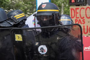 A riot police look into the camera during the riot on the May Day demonstration in Paris. Tens of thousands of trade unionists and grassroots activists gathered in Paris to celebrate the achievements of the labor movement and raise awareness of workers’ rights.