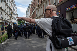 A protester confronts the riot police during the May Day demonstration in Paris. Tens of thousands of trade unionists and grassroots activists gathered in Paris to celebrate the achievements of the labor movement and raise awareness of workers’ rights.