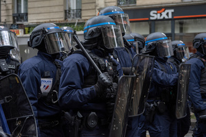 Riot police ready to intervene to the demonstration while they stand by the road during the May Day protest in Paris. Tens of thousands of trade unionists and grassroots activists gathered in Paris to celebrate the achievements of the labor movement and raise awareness of workers’ rights.