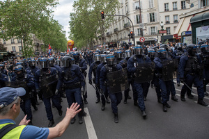 Riot police walks towards the protesters during the May Day demonstration in Paris. Tens of thousands of trade unionists and grassroots activists gathered in Paris to celebrate the achievements of the labor movement and raise awareness of workers’ rights.