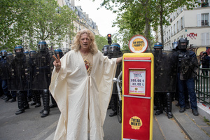 A protester dressed as Jesus poses front of the riot police with a fuel pump to protest against the rising fuel prices during the May Day protest in Paris. Tens of thousands of trade unionists and grassroots activists gathered in Paris to celebrate the achievements of the labor movement and raise awareness of workers’ rights.