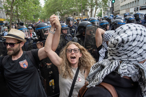 Protesters walks hand in hand and chant slogans during the May Day demonstration in Paris. Tens of thousands of trade unionists and grassroots activists gathered in Paris to celebrate the achievements of the labor movement and raise awareness of workers’ rights.