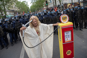 A protester dressed as Jesus poses front of the riot police with a fuel pump to protest against the rising fuel prices during the May Day protest in Paris. Tens of thousands of trade unionists and grassroots activists gathered in Paris to celebrate the achievements of the labor movement and raise awareness of workers’ rights.