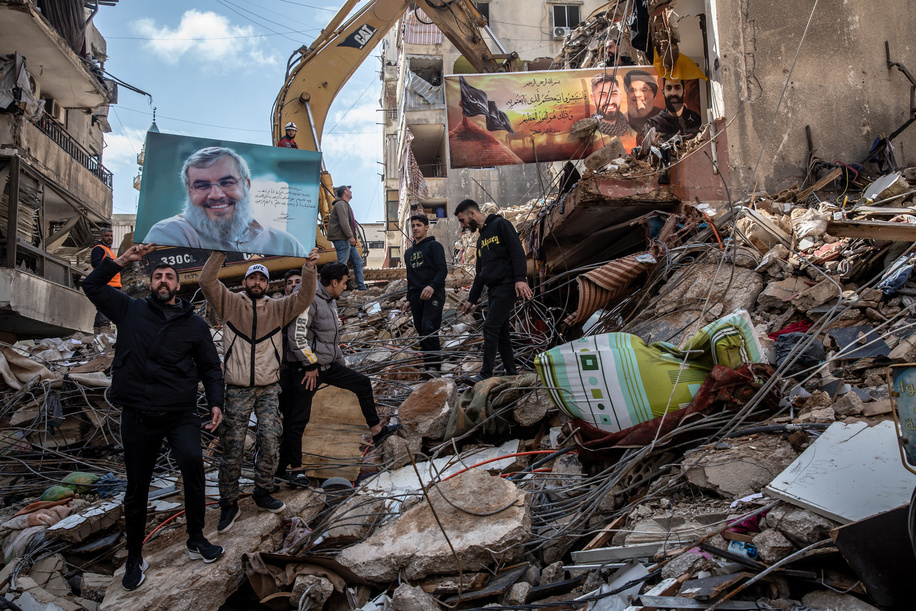 Hezbollah supporters hold up a picture of assassinated Secretary General Hassan Nasrallah at Hey al-Soulom, in Beirut's southern suburbs, where a search for bodies was still ongoing two days after an airstrike on a supermarket and residential building killed dozens of people. All-out war between Israel and Hezbollah restarted on March 2, after Hezbollah fired rockets towards Israeli territory, following a 15-month ceasefire where Israel continued to attack on a near-daily basis.