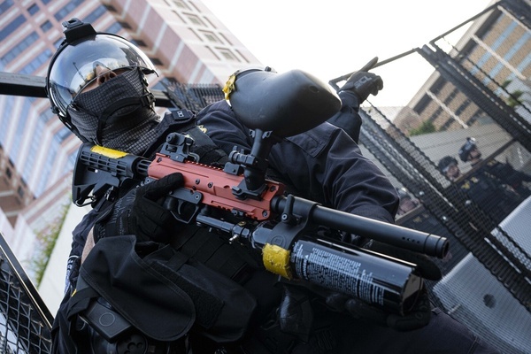 A DHS officer seen with a less-lethal weapon as tensions rise against protesters. Protesters clash with DHS officers at the Metropolitan Detention Center (MDC) in Los Angeles, during the nationwide "Mayday" protests occurring across the United States.