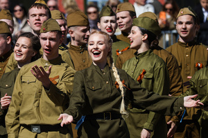 A group of young people in historical Red Army uniforms of the World War II era sing and cheer during a theatrical performance at the Peter and Paul Fortress. A large-scale theatrical reconstruction and flash mob titled "Victory Ball" (Bal Pobedy) takes place on the Cathedral Square of the Peter and Paul Fortress. The event is dedicated to the 81st anniversary of the victory in World War II (WWII). Hundreds of participants, including youth activists, members of the Yunarmia movement, and students in historical and modern military uniforms, perform mass dances and formations. The reconstruction is part of the city-wide celebrations ahead of Victory Day in St. Petersburg.