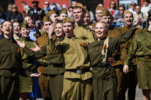A group of young people in historical Red Army uniforms of the World War II era sing and cheer during a theatrical performance at the Peter and Paul Fortress. A large-scale theatrical reconstruction and flash mob titled "Victory Ball" (Bal Pobedy) takes place on the Cathedral Square of the Peter and Paul Fortress. The event is dedicated to the 81st anniversary of the victory in World War II (WWII). Hundreds of participants, including youth activists, members of the Yunarmia movement, and students in historical and modern military uniforms, perform mass dances and formations. The reconstruction is part of the city-wide celebrations ahead of Victory Day in St. Petersburg.