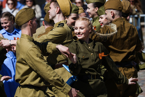 A group of young people in historical Red Army uniforms of the World War II era sing and cheer during a theatrical performance at the Peter and Paul Fortress. A large-scale theatrical reconstruction and flash mob titled "Victory Ball" (Bal Pobedy) takes place on the Cathedral Square of the Peter and Paul Fortress. The event is dedicated to the 81st anniversary of the victory in World War II (WWII). Hundreds of participants, including youth activists, members of the Yunarmia movement, and students in historical and modern military uniforms, perform mass dances and formations. The reconstruction is part of the city-wide celebrations ahead of Victory Day in St. Petersburg.