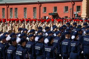Cadets from the Police Academy in dark blue uniforms stand in formation facing members of the Yunarmia movement during the "Victory Ball" theatrical reconstruction at the Peter and Paul Fortress. A large-scale theatrical reconstruction and flash mob titled "Victory Ball" (Bal Pobedy) takes place on the Cathedral Square of the Peter and Paul Fortress. The event is dedicated to the 81st anniversary of the victory in World War II (WWII). Hundreds of participants, including youth activists, members of the Yunarmia movement, and students in historical and modern military uniforms, perform mass dances and formations. The reconstruction is part of the city-wide celebrations ahead of Victory Day in St. Petersburg.