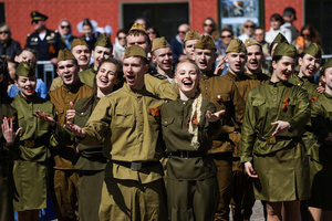 A group of young people in historical Red Army uniforms of the World War II era sing and cheer during a theatrical performance at the Peter and Paul Fortress. A large-scale theatrical reconstruction and flash mob titled "Victory Ball" (Bal Pobedy) takes place on the Cathedral Square of the Peter and Paul Fortress. The event is dedicated to the 81st anniversary of the victory in World War II (WWII). Hundreds of participants, including youth activists, members of the Yunarmia movement, and students in historical and modern military uniforms, perform mass dances and formations. The reconstruction is part of the city-wide celebrations ahead of Victory Day in St. Petersburg.