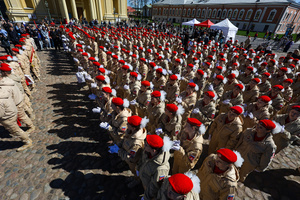 A large group of the Yunarmia youth movement members in signature red berets standing in formation during a festive flash mob at the Peter and Paul Fortress. A large-scale theatrical reconstruction and flash mob titled "Victory Ball" (Bal Pobedy) takes place on the Cathedral Square of the Peter and Paul Fortress. The event is dedicated to the 81st anniversary of the victory in World War II (WWII). Hundreds of participants, including youth activists, members of the Yunarmia movement, and students in historical and modern military uniforms, perform mass dances and formations. The reconstruction is part of the city-wide celebrations ahead of Victory Day in St. Petersburg.