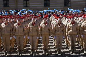 A large group of the Yunarmia youth movement members in signature red berets standing in formation during a festive flash mob at the Peter and Paul Fortress. A large-scale theatrical reconstruction and flash mob titled "Victory Ball" (Bal Pobedy) takes place on the Cathedral Square of the Peter and Paul Fortress. The event is dedicated to the 81st anniversary of the victory in World War II (WWII). Hundreds of participants, including youth activists, members of the Yunarmia movement, and students in historical and modern military uniforms, perform mass dances and formations. The reconstruction is part of the city-wide celebrations ahead of Victory Day in St. Petersburg.