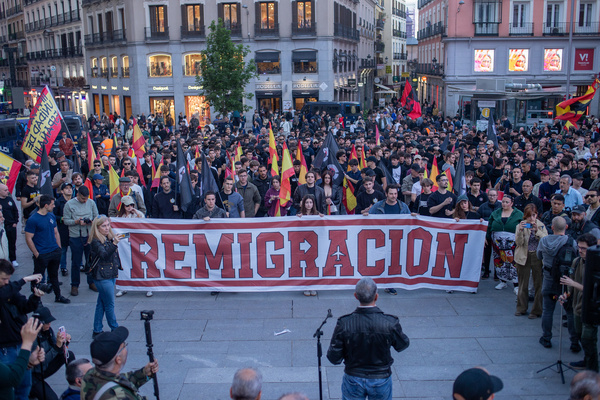 Far-right demonstrators carry a banner with the word "Remigration during a demonstration organized by the Spanish far-right group Falange Española to demand what they call "Remigration," or the mass expulsion of immigrants to their countries of origin.