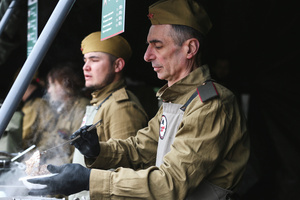 Volunteer wearing military clothing works at a street food kiosk as field kitchen during the celebrating Victory Day at the Exhibition of Achievements of the National Economy (VDNKh) Moscow marked the 81st anniversary of the Soviet victory over Nazi Germany on May 9 with commemorative events across the city honoring those who fought in World War II. Some residents took part in memorial activities remembering the wartime generation.