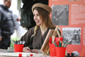 Volunteer wearing military clothing works in booth during the celebrating Victory Day at the Exhibition of Achievements of the National Economy (VDNKh) Moscow marked the 81st anniversary of the Soviet victory over Nazi Germany on May 9 with commemorative events across the city honoring those who fought in World War II. Some residents took part in memorial activities remembering the wartime generation.
