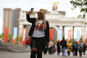 A woman wearing a St. George ribbons seen taking pictures during the celebration of Victory Day at the Exhibition of Achievements of the National Economy (VDNKh) Moscow marked the 81st anniversary of the Soviet victory over Nazi Germany on May 9 with commemorative events across the city honoring those who fought in World War II. Some residents took part in memorial activities remembering the wartime generation.