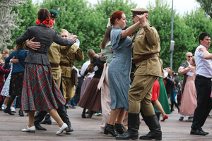 People dance during the Victory Day celebrations at Gorky Park in central Moscow. People wearing vintage clothing and Soviet-era uniforms gathered at Gorky Park, where some participants performed the traditional “Victory Waltz” during commemorations in Moscow. The dance honors the wartime generation and remains a symbolic part of Victory Day celebrations.