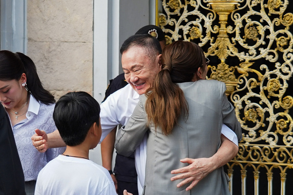 Former Thai Prime Minister Thaksin Shinawatra hugs his daughter, Pintontha Kunakornwong, after his release on parole at Central Prison.