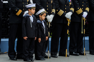 Two children watch the 147th commemoration parade of Naval Glories Day. Commemoration number 147 of Naval Glories Day, with the presence of the president of Chile Jose Antonio Kast, in the city of Valparaiso, Chile.