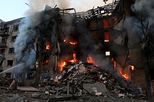Firefighters work at the scene of a fire in a destroyed apartment building as a result of a Russian missile attack. A large ballistic missile attack pounded Kyiv early on May 24, authorities said, wounding at least five people after Moscow threatened retaliation for strikes in Russian-occupied eastern Ukraine.