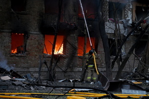 Firefighters work at the scene of a fire in a destroyed apartment building as a result of a Russian missile attack. A large ballistic missile attack pounded Kyiv early on May 24, authorities said, wounding at least five people after Moscow threatened retaliation for strikes in Russian-occupied eastern Ukraine.