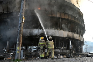 Ukrainian firefighters try to stop fire in a heavily damaged building following Russian strikes in Kyiv. A large ballistic missile attack pounded Kyiv early on May 24, authorities said, wounding at least five people after Moscow threatened retaliation for strikes in Russian-occupied eastern Ukraine.