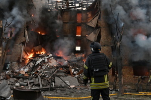 Firefighters work at the scene of a fire in a destroyed apartment building as a result of a Russian missile attack. A large ballistic missile attack pounded Kyiv early on May 24, authorities said, wounding at least five people after Moscow threatened retaliation for strikes in Russian-occupied eastern Ukraine.