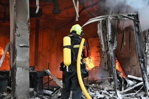 Ukrainian firefighters try to stop fire in a heavily damaged building following Russian strikes in Kyiv. A large ballistic missile attack pounded Kyiv early on May 24, authorities said, wounding at least five people after Moscow threatened retaliation for strikes in Russian-occupied eastern Ukraine.