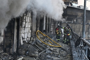Ukrainian firefighters try to stop fire in a heavily damaged building following Russian strikes in Kyiv. A large ballistic missile attack pounded Kyiv early on May 24, authorities said, wounding at least five people after Moscow threatened retaliation for strikes in Russian-occupied eastern Ukraine.