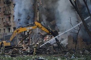 Firefighters work at the scene of a fire in a destroyed apartment building as a result of a Russian missile attack. A large ballistic missile attack pounded Kyiv early on May 24, authorities said, wounding at least five people after Moscow threatened retaliation for strikes in Russian-occupied eastern Ukraine.