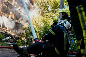 Firefighters work at the scene of a fire in a destroyed apartment building as a result of a Russian missile attack. A large ballistic missile attack pounded Kyiv early on May 24, authorities said, wounding at least five people after Moscow threatened retaliation for strikes in Russian-occupied eastern Ukraine.
