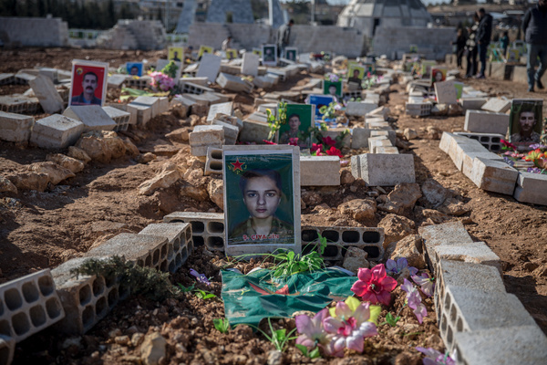 A recent grave at the Martyrs’ Cemetery in Kobane, where graves of Women's Defense Units (YPJ) and People's Defense Units (YPG) fighters, and members of the Asayish internal security forces killed in fighting with government forces in January, are visible beside older graves of those killed fighting ISIS. The Kurdish-led Syrian Democratic Forces (SDF) lost huge swathes of territory in January, leaving the northern Syrian city isolated.