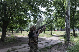The Ukrainian police unit ‘White Angels officer’ attempts to shoot down a Russian drone during a civilian evacuation.
