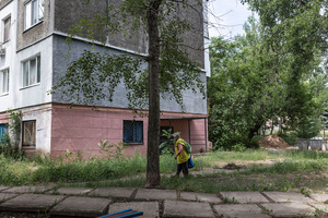 A woman seen walking down a street in the city.