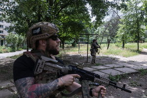 The Ukrainian police unit ‘White Angels officer’ attempts to shoot down a Russian drone during a civilian evacuation.