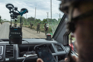 Ukrainian soldiers seen walking along a road during a civilian evacuation organised by the ‘White Angels’ police unit.