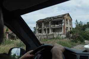A building damaged by Russian bombing seen from an evacuation vehicle during a civilian evacuation carried out by the ‘White Angels’ police unit.