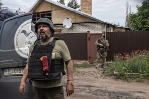 The ‘White Angels’ police unit officers monitors drones during a civilian evacuation.